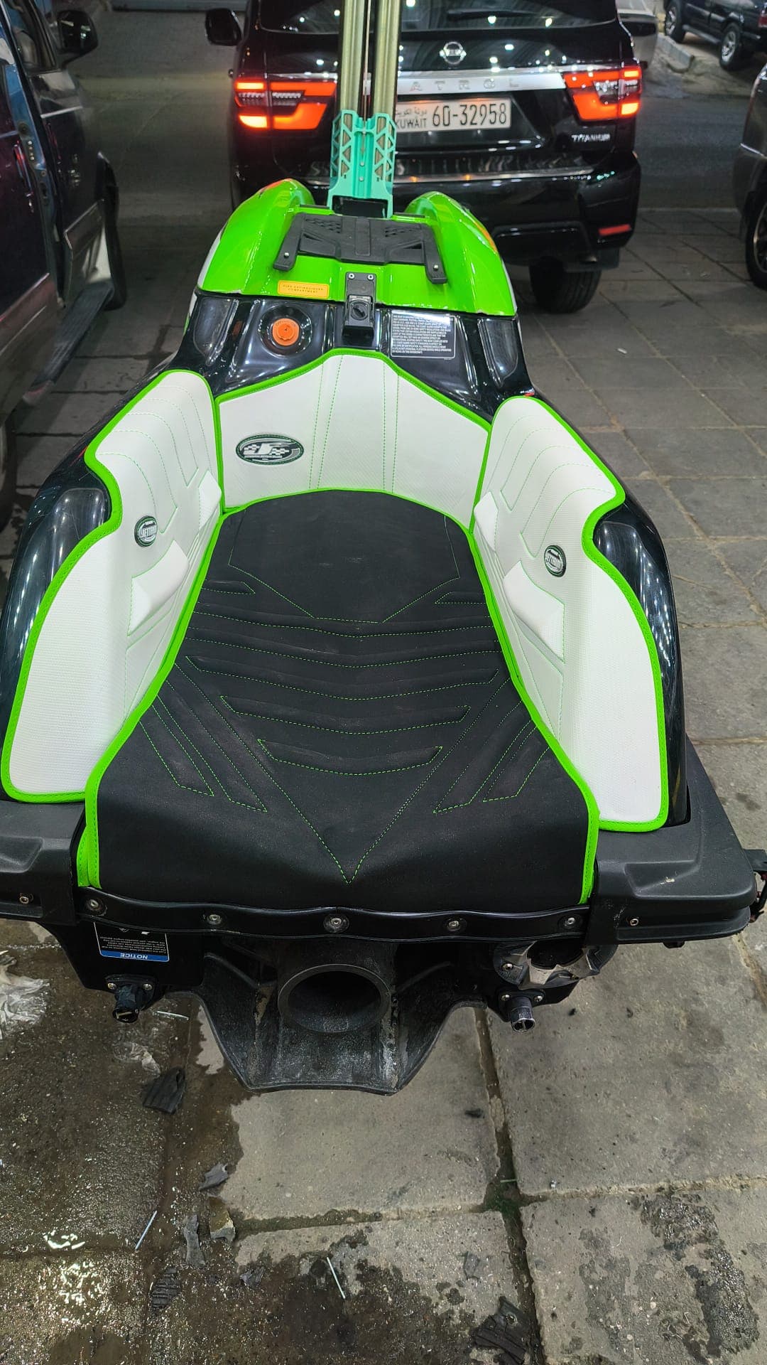 Green and white custom jet ski seat upholstery installed on a personal watercraft by Shakeel Marine in Kuwait