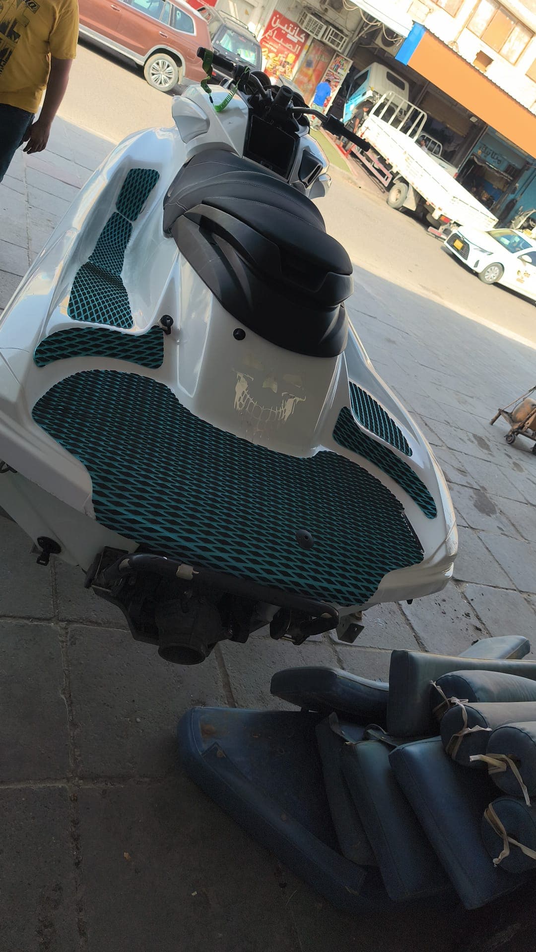 Textured floor mat aligned around a jet ski drain fitting by Shakeel Marine in Kuwait